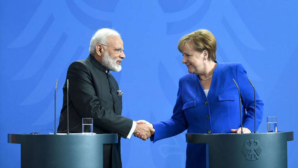 Indian Prime Minister Narendra Modi and German Chancellor Angela Merkel shaking hands.